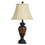 Sienna Table Lamp With Its Antiqued Warm Wood Finish And Coordinating Cream Bell Shade